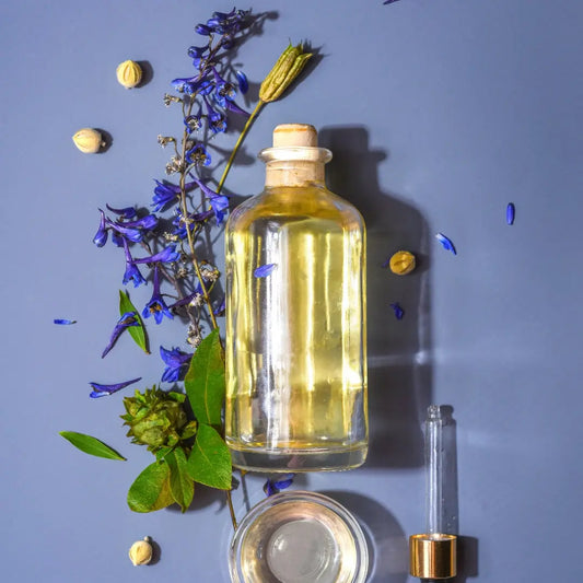 a hair oil bottle on the floor with herbs